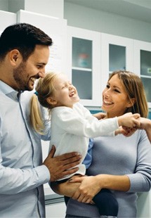 man smiling while holding dental mirror 