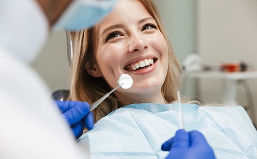 Lady smiles at dentist